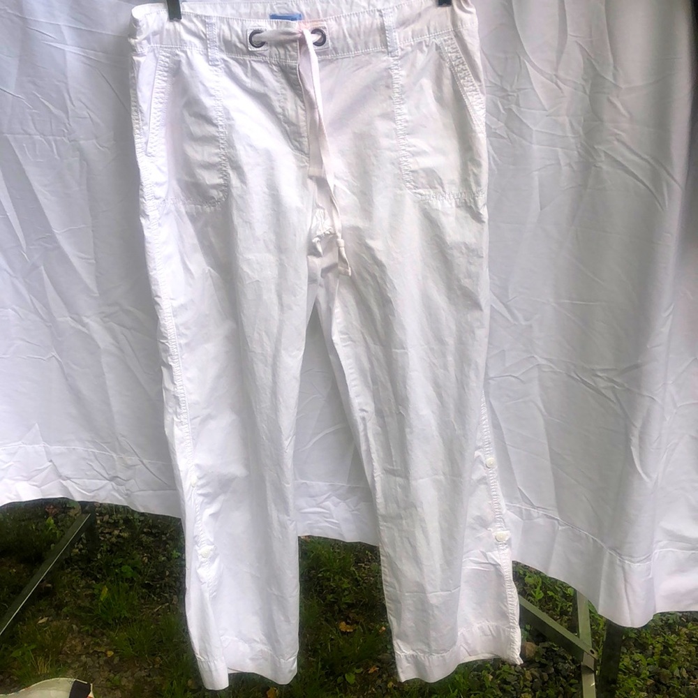 I I’d pants/Capris, white , size 12.  stain from washing, front.